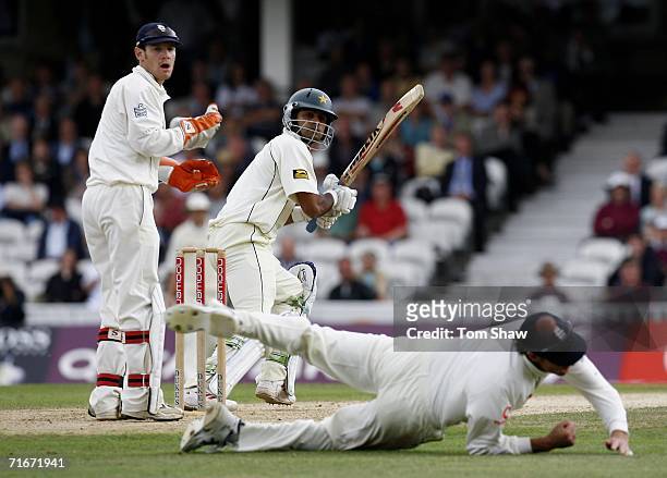 Mohammad Hafeez of Pakistan edges past Marcus Trescothick of England as wicketkeeper Chris Read reacts during day two of the fourth npower test match...