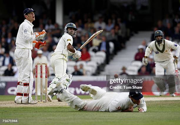 Mohammad Hafeez of Pakistan edges past Marcus Trescothick of England as wicketkeeper Chris Read reacts during day two of the fourth npower test match...