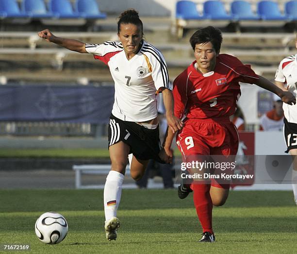 Ri Song Sim of Korea vies for the ball with Fatmire Bajramaj of Germany during the FIFA Women's Under 20 World Championships Group C match between...