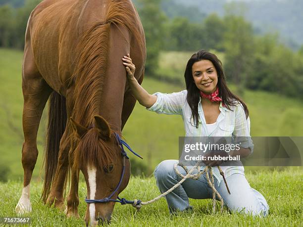 portrait of a woman holding the reins of a horse - gateado imagens e fotografias de stock