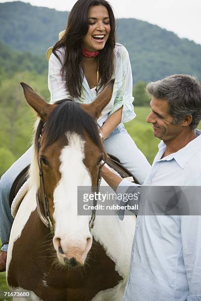 woman sitting on a horse with a man beside her - gateado imagens e fotografias de stock