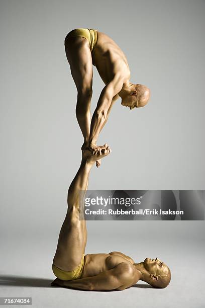 two male acrobats performing - body paint imagens e fotografias de stock