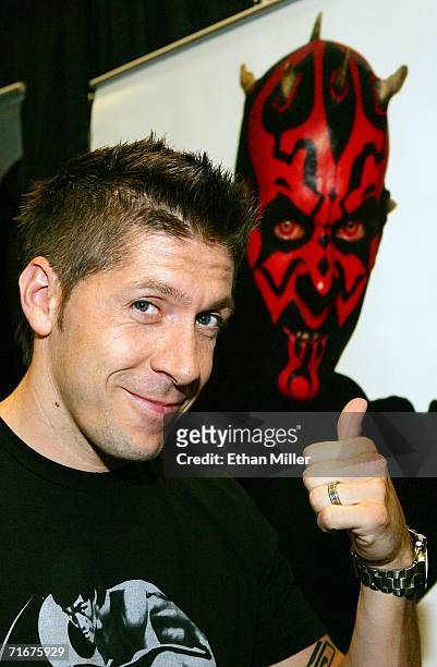 Actor Ray Park poses in front of an image of Darth Maul, the character he played in the movie "Star Wars: Episode I - The Phantom Menace," at the...