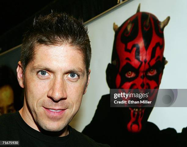 Actor Ray Park poses in front of an image of Darth Maul, the character he played in the movie "Star Wars: Episode I - The Phantom Menace," at the...