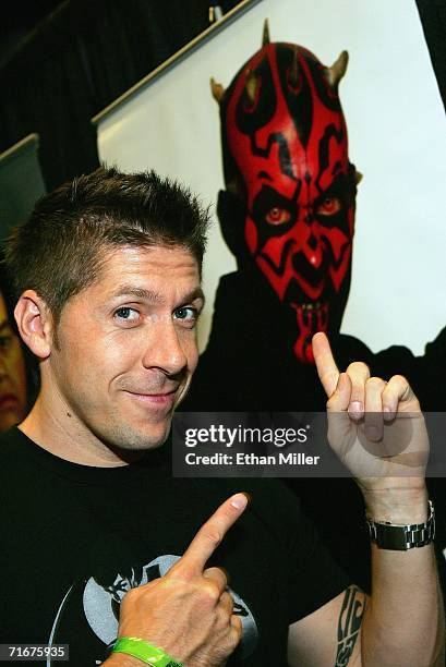 Actor Ray Park poses in front of an image of Darth Maul, the character he played in the movie "Star Wars: Episode I - The Phantom Menace," at the...