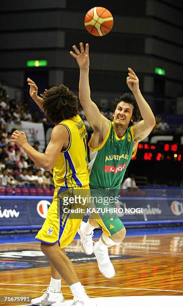 Australian power forward player Andrew Bogut tries to shot as Brazil's Anderson Varejao blocks during their Group C opening match at the World...