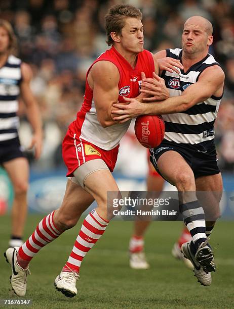 Sean Dempster for Sydney contests with Paul Chapman for Geelong during the round 20 AFL match between the Geelong Cats and the Sydney Swans at...