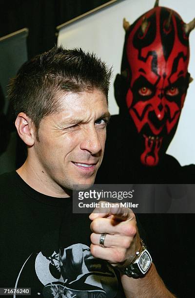 Actor Ray Park poses in front of an image of 'Darth Maul', the character he played in the movie "Star Wars: Episode I - The Phantom Menace," at the...