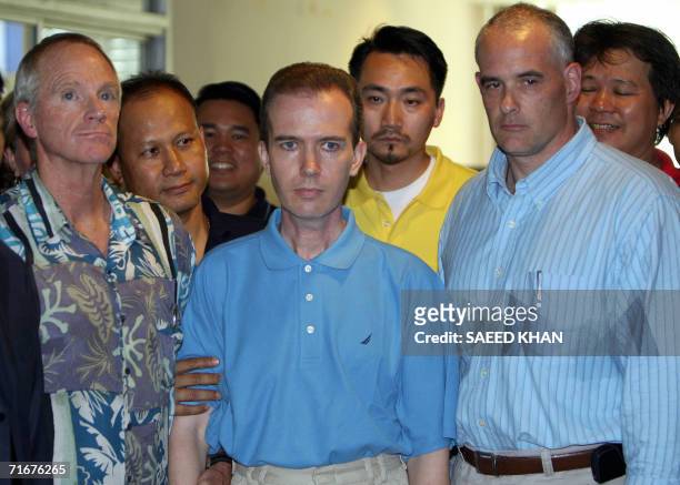 Picture dated 17 August 2006 shows US teacher John Mark Karr flanked by US and Thai security officials at the Thai Immigration Department in Bangkok....