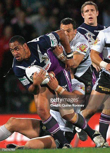 Antonio Kaufusi of the Storm is tackled during the round 24 NRL match between the Melbourne Storm and the Warriors at Olympic Park on August 19, 2006...
