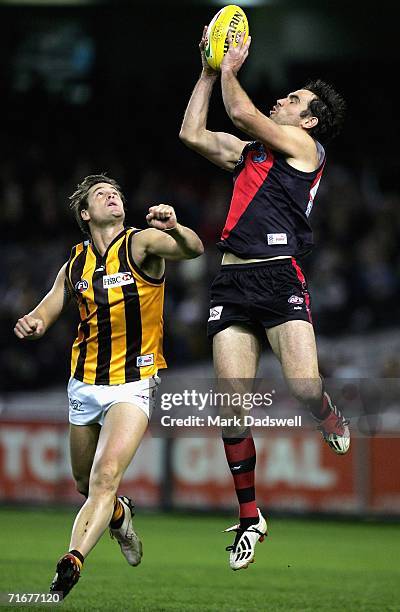 Scott Lucas of the Bombers marks ahead of Trent Croad of the Hawks during the round 20 AFL match between the Essendon Bombers and the Hawthorn Hawks...