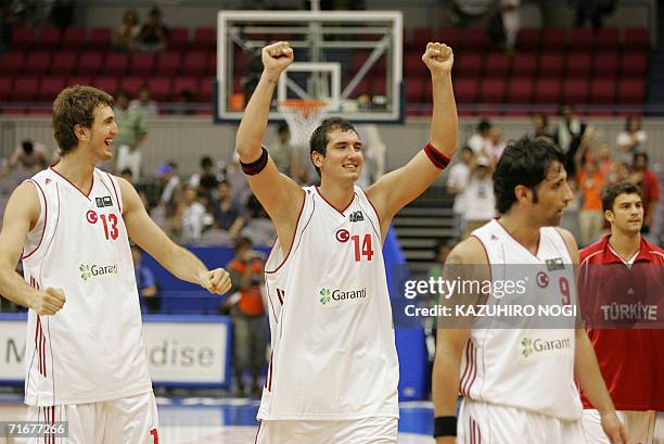 Turkey's Kaya Peker celebrates with teammate Semih Edren their win against Lithuania in the Group C qualiyfing match at the World Basketball...