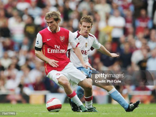 Alexander Hleb of Arsenal holds off the challenge of Steven Davis of Aston Villa during the Barclays Premiership match between Arsenal and Aston...