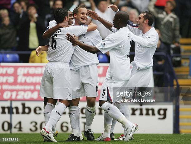 Kevin Davies of Bolton Wanderers celebrates with team mates after scoring the opening goal during the Barclays Premiership match between Bolton...