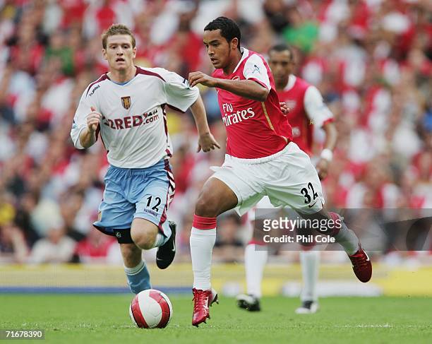 Theo Walcott of Arsenal is chased by Steven Davis of Aston Villa during the Barclays Premiership match between Arsenal and Aston Villa at The...