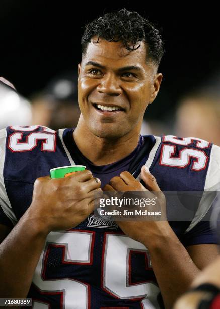Junior Seau of the New England Patriots smiles from the sidelines as his team plays the Arizona Cardinals during their pre season game on August19,...