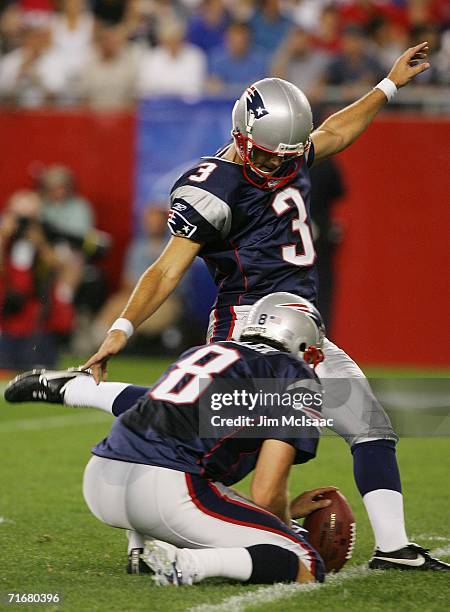 Stephen Gostkowski of the New England Patriots kicks an extra point as teammate Josh Miller holds against the Arizona Cardinals during their pre...