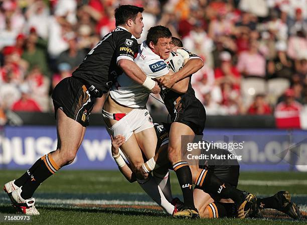 Clint Greenshields of the Dragons is tackled by the Tigers defence during the round 24 NRL match between the St. George Illawarra Dragons and the...