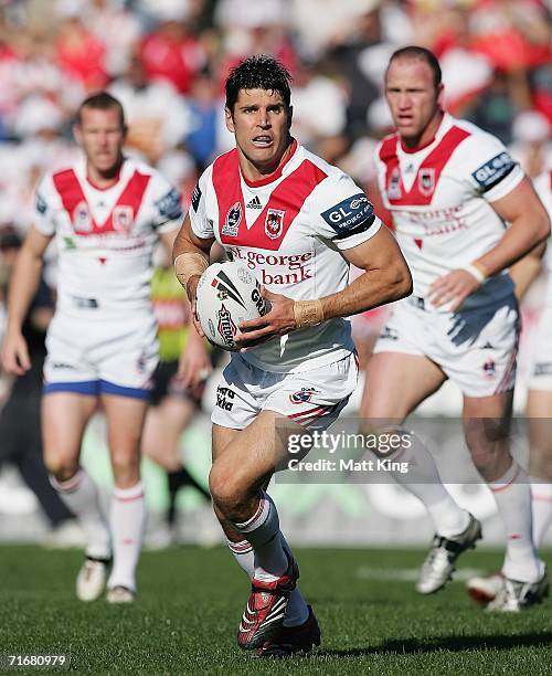 Trent Barrett of the Dragons runs with the ball during the round 24 NRL match between the St. George Illawarra Dragons and the Wests Tigers at Oki...