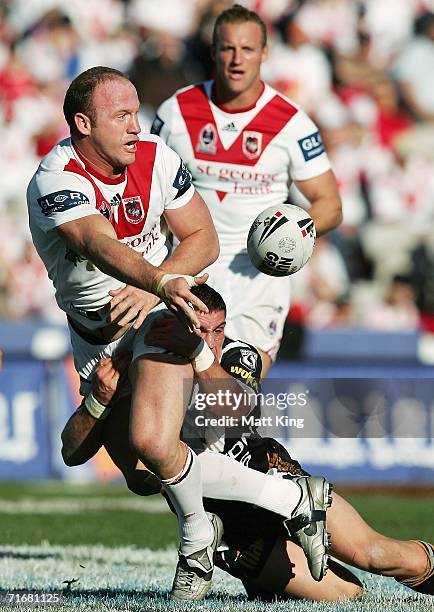 Luke Bailey of the Dragons gets a pass away during the round 24 NRL match between the St. George Illawarra Dragons and the Wests Tigers at Oki...