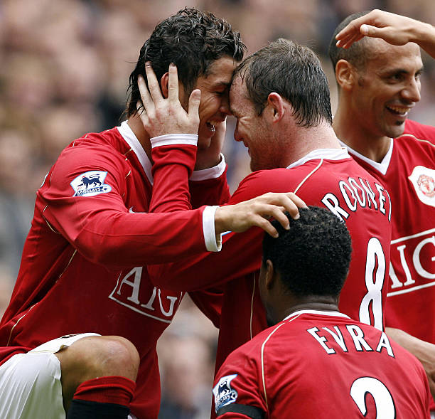 Manchester, UNITED KINGDOM: Manchester United's Cristiano Ronaldo celebrates his goal against Fulham with Wayne Rooney during their English...