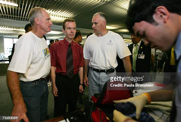 American John Mark Karr is escorted by U.S. Security officials as he arrives at Gate 46 for his flight to Los Angeles on Thai Airways at Bangkok...