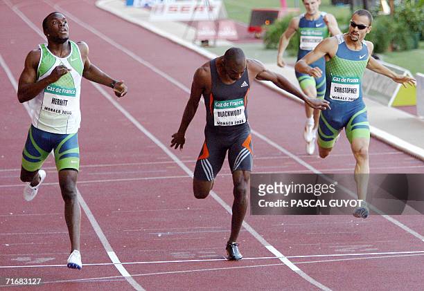 Lashawn Merrit, Jamaican Michael Blackwood and Canadian Tyler Christopher cross the finish line of the men 400 meters race during the IAAF athletics...