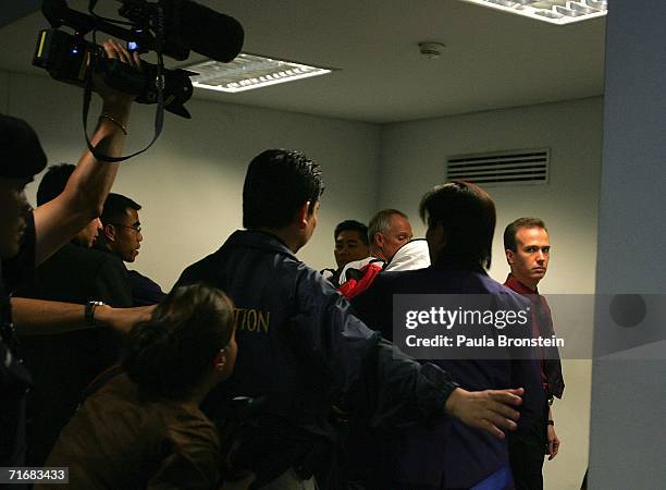 American John Mark Karr , escorted by U.S. Security officials, boards his Thai Airlines flight to Los Angeles at Gate 46 at Bangkok international...