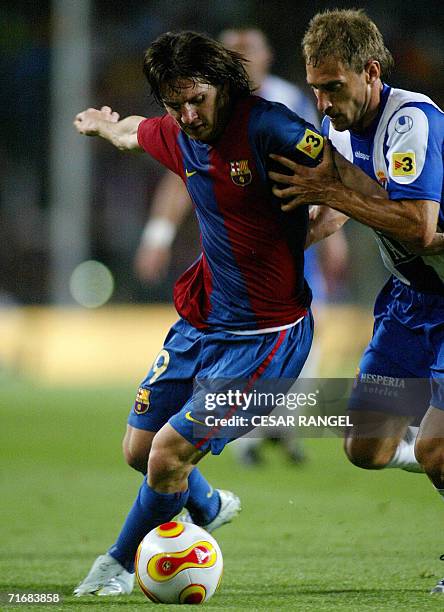 Barcelona's Leo Messi of Argentina vies with Espanyol's Zabaleta during their Spanish Supercup Final football match at the Camp Nou Stadium in...