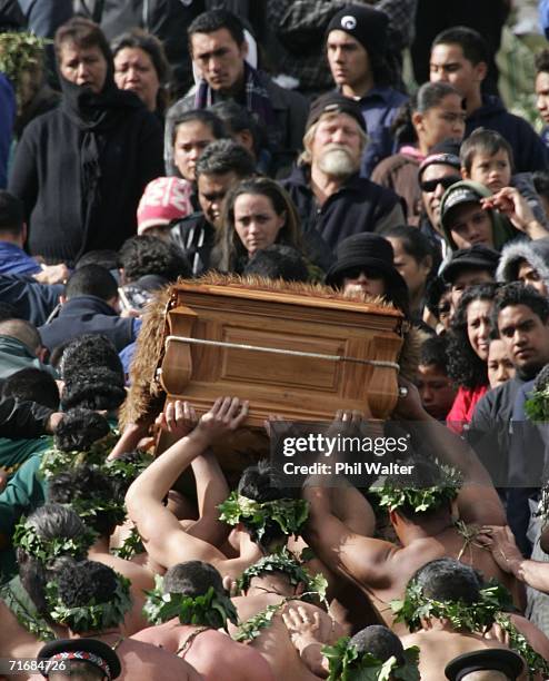 The coffin of the Maori Queen, Dame Te Atairangikaahu is lifted by pallbearers up the sacred Taupiri Mountain following its journey down the Waikato...