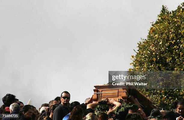 The coffin of the Maori Queen, Dame Te Atairangikaahu is lifted by pallbearers up the sacred Taupiri Mountain following its journey down the Waikato...
