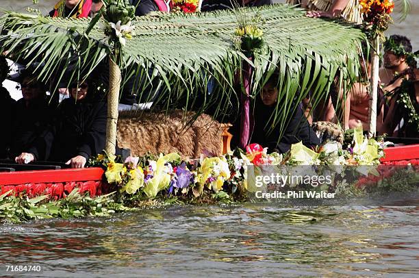The coffin of the Maori Queen, Dame Te Atairangikaahu is transported on a waka down the Waikato River towards her final resting place on top of the...