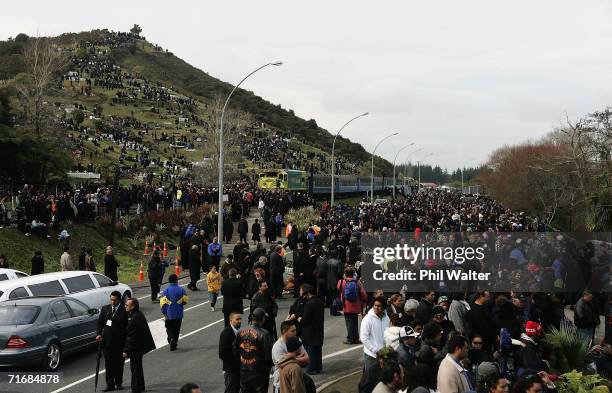 Thousands of people wait on the road and the sacred Taupiri Mountain for the coffin of the Maori Queen Dame Te Atairangikaahu following its journey...