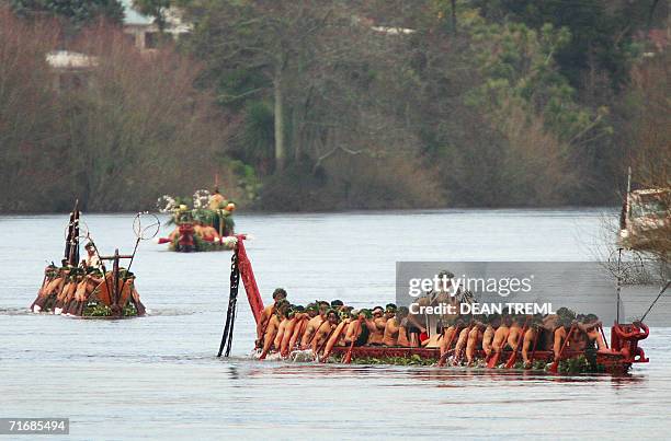 Maori Warriors in two waka escort the waka carrying the coffin of Queen Te Arikinui Dame Te Atairangikaahu down the Waikato river toward mount...