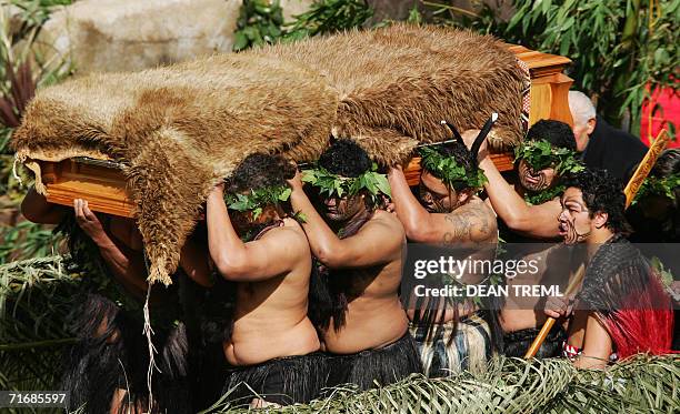 Maori Warriors carry the coffin of Queen Te Arikinui Dame Te Atairangikaahu from the Waikato River to the top of Mount Taupiri to her final resting...