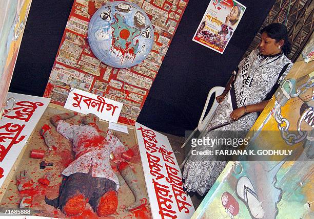 Injured Bangladeshi woman Kajol looks at a tableau representing a grenade victim in Dhaka, 21 August 2006, on the second anniversary of a grenade...
