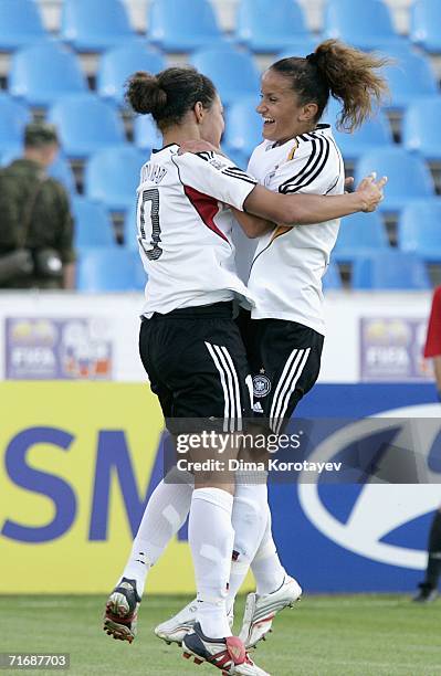 Celia Okoyino Da Mbabi and Fatmire Bajramaj of Germany celebrate after scoring a goal during the FIFA Women's Under 20 World Championships Group C...