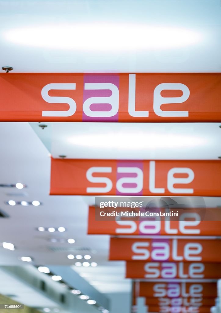 Sale signs hanging from ceiling