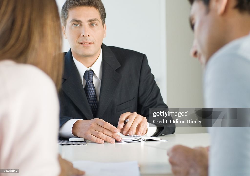 Couple having meeting with businessman