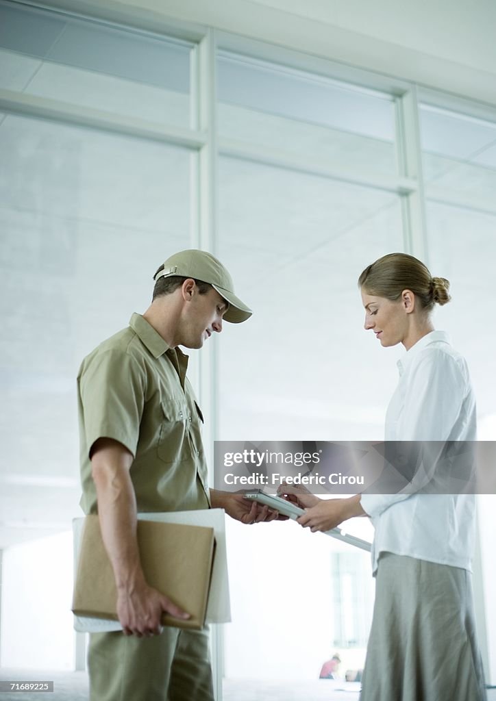 Receptionist signing for delivery