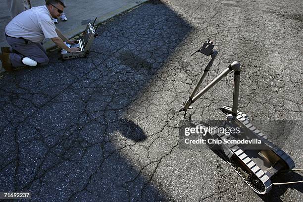 IRobot employee Gary Stair uses the "PacBot Scout" to try to pick up a set of keys during a demonstration at the Montgomery County Fire Rescue...