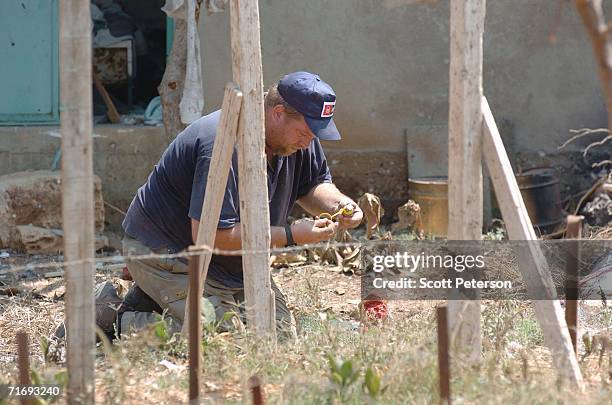 Swedish deminer Magnus Rundstrom of of the Mine Advisory Group diffuses a cluster bomb August 21, 2006 in Yohmor, Lebanon. MAG is clearing areas of...
