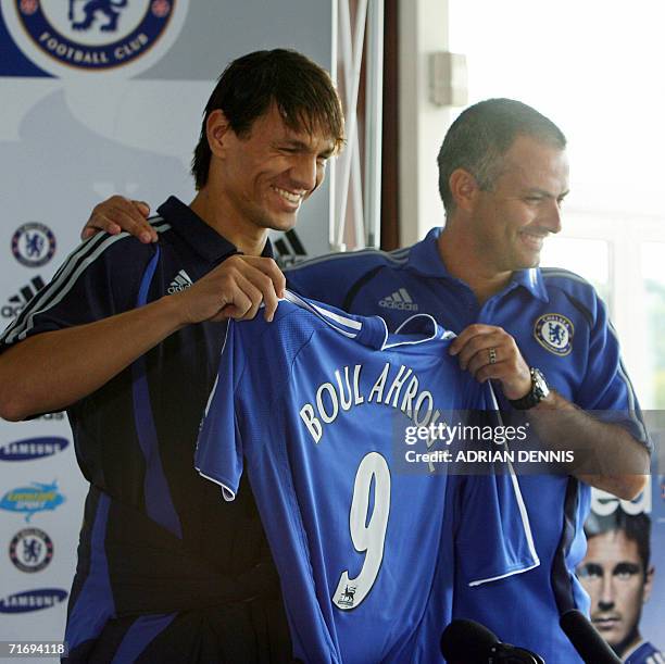 Cobham, UNITED KINGDOM: Dutch international defender Khalid Boulahrouz poses with Chelsea manager Jose Mourinho during a press conference at the...