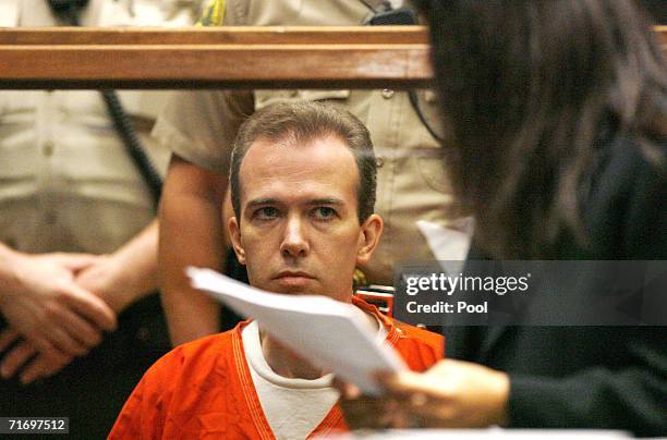 John Mark Karr, the suspect in the killing of child beauty queen JonBenet Ramsey, looks at deputy public defender Haydeh Takasugi during an...