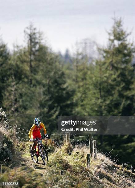 Ren Chengyuan of China climbs up the slopes of Mount Ngongotaha with Lake Rotorua in the background during the U23 Women's Cross Country competition...