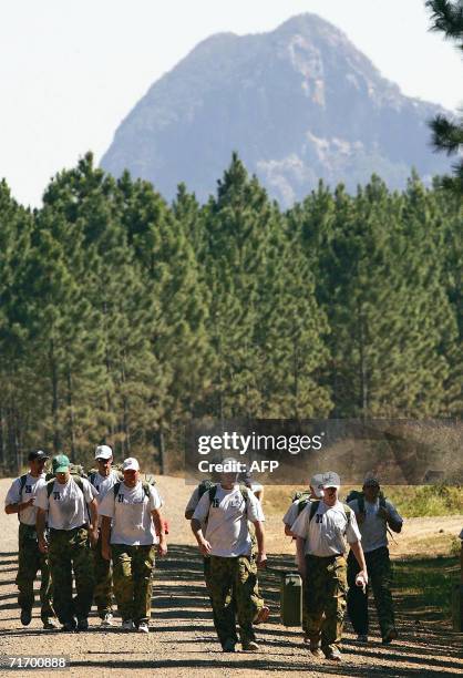 The Australian cricket team walk along a track during an outback boot camp training session in the Beerwah State Forest, 23 August 2006, near...