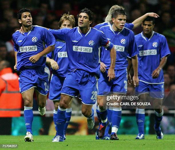 London, UNITED KINGDOM: Team mates congratulate Dinamo Zagreb's Eduardo during their Champions League qualifying match against Arsenal in London, 23...