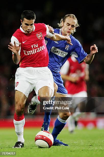 Robin Van Persie of Arsenal breaks away from Jasmin Agic of Zagreb during the UEFA Champions League Qualification Third qualifying round second leg...