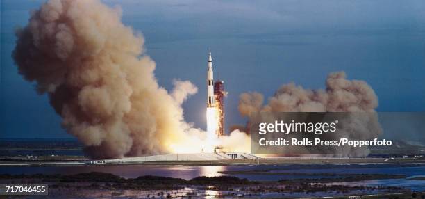 View of a Saturn V rocket blasting off during launch from Kennedy Space Center, carrying the Apollo 8 crew of NASA astronauts, Commander Frank...