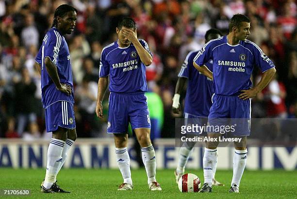 Didier Drogba, Frank Lampard and Andriy Shevchenko of Chelsea show their dejection as they prepare to kick off after conceding a goal in the final...